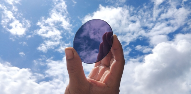 Light adaptive lenses held against the sky