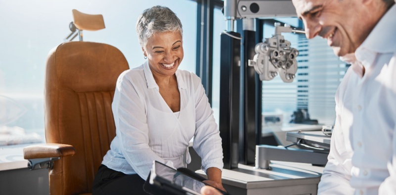 A woman having a consultation with her optometrist at the opticians.
