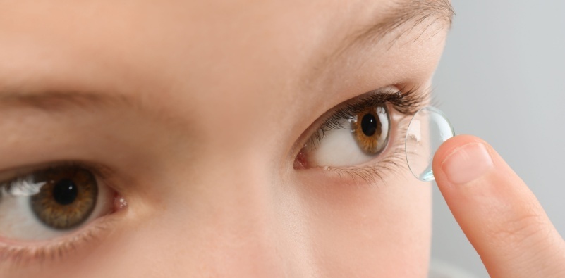 Child applying contact lenses