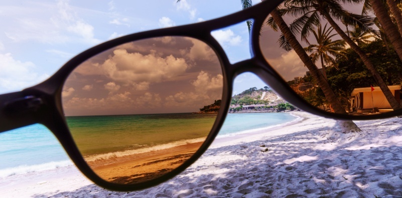 Beach view through sunglasses lenses