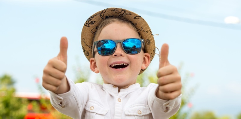 Child wearing sunglasses and wide-brimmed hat