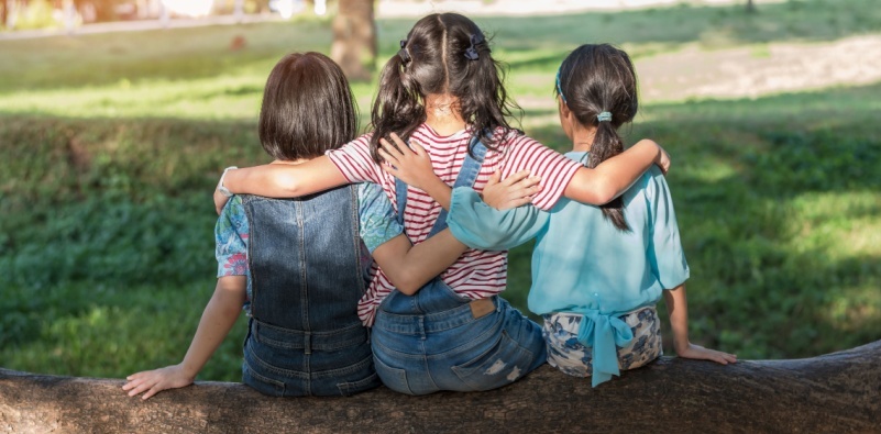 Group of kids sitting in the shade