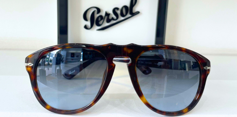 649 Persol sunglasses in front of brand sign