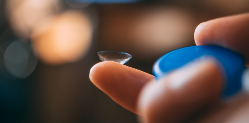 contact lens balanced on fingertip