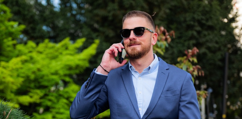 Man in suit wearing sunglasses outdoors
