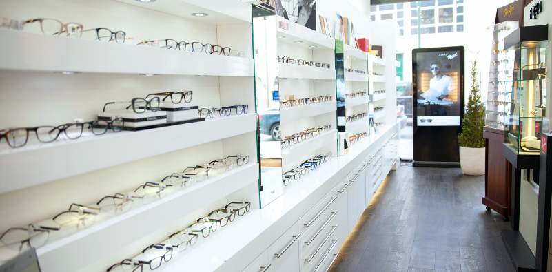 Optikal Opticians practice interior in Potters Bar, Finchley and Temple Fortune, displaying Porsche Design sunglasses and designer eyewear frames.]