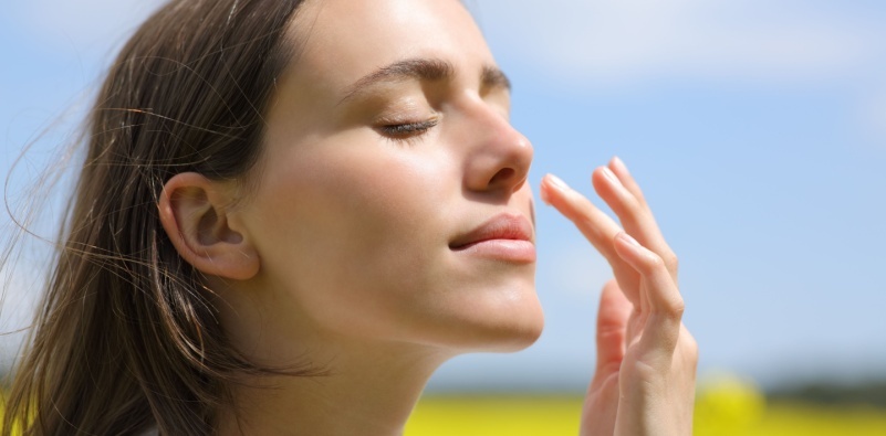 Woman resting with a cold compress over her eyes
