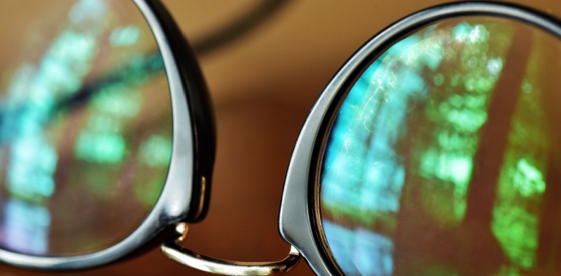 A close up of a pair of black glasses with an anti glare coating.