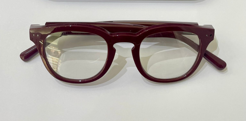 A pair of burgundy Nuance Audio glasses on a white background.]